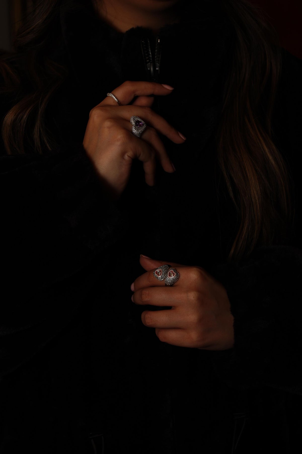NOHO pave heart rings worn with a black faux-fur jacket